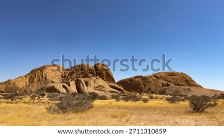 The Spitzkoppe mountain range in Namibia consists of pink smooth extraordinary boulders