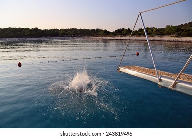 Splash After Jumping Into The Water From A Boat. Leisure And Entertainment, Croatia