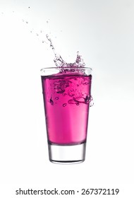 Splash In A Glass Of Pink Lemonade Isolated On White Background