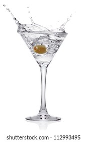 Splash from olive in a glass of cocktail, isolated on the white background, clipping path included.