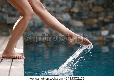 Splash, pool and vacation with feet in water, woman and legs with closeup, sunshine and weekend break. Person, wet and fun with summer and swimming with hotel and hospitality with holiday and playful