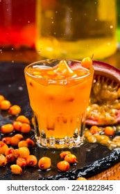 splash sea buckthorn liqueur in a glass close-up. Sallow-thorn liqueur wit sallow-thorn berries on bar background - Shutterstock ID 2241822845