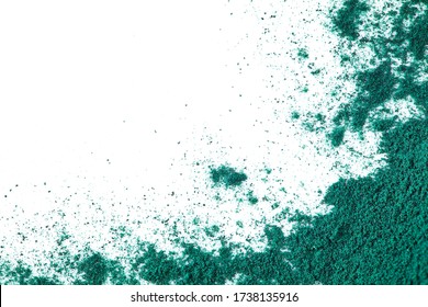 Splash of spirulina algae powder on a white background. Superfood concept. Top view.