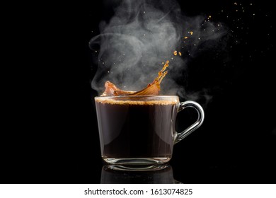 Splash And Splatter From A Piece Of Sugar In A Mug With Coffee On A Black Background