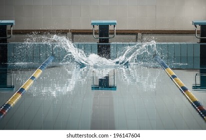 Splashes after swimmers jump in a swimming pool 