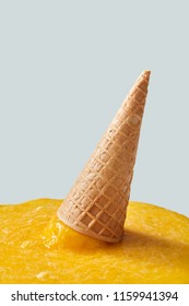 Splashes of fruit ice cream on a gray background. Falling crispy waffle cone of ice cream. Copy space for text