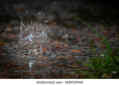 Splashes Of Rain Water Dripping Off The Roof