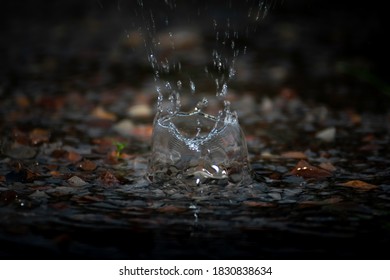 Splashes Of Rain Water Dripping Off The Roof