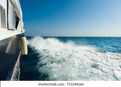 Splashes of sea water from the wake of the boat.