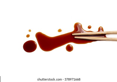 splashes of soy sauce and chopsticks isolated on white. wooden chopsticks dipped in soy sauce spilled. splashes and drops of isolated on white background. flat lay, top view - Powered by Shutterstock