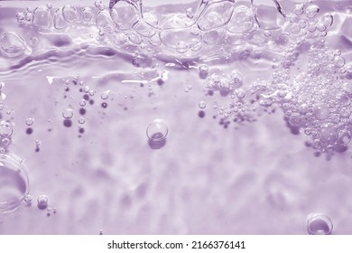 splashing cosmetic moisturizer, micellar water, toner, or emulsion abstract background. Transpatent texture with bubbles