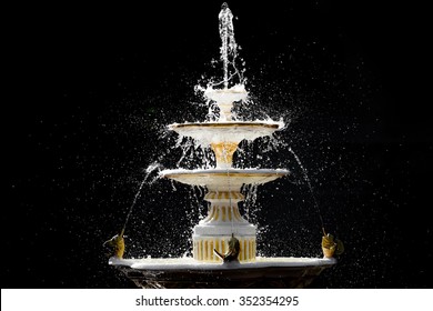 Splashing fountain in four levels on dark background