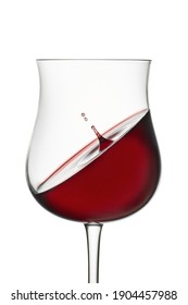 Splashing in glass. Red wine in wineglass isolated on white background. Drop falls into glass and creates splash and wave on surface of red wine