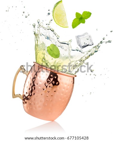 splashing moscow mule cocktail in copper mug isolated