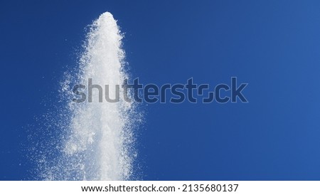 Splashing water in the blue sky from a water fountain