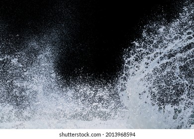 splashing water of sea wave from storm crashing on shore spraying white water foam and bubble in air isolated on black background with clipping path - Powered by Shutterstock