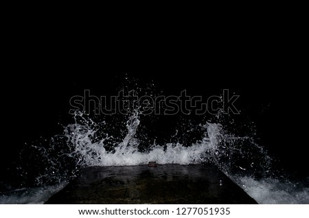 Splashing wave on the Black sea in the night.