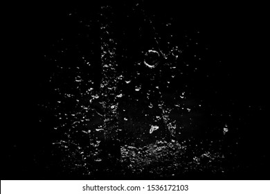 Splatter water drop has be motionless on a black texture background