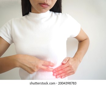 Spleen Ruptures In Women. She Touched Her Chest And Experienced Pain And Suffering. Health Care Concept. Closeup Photo, Blurred.