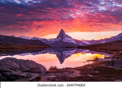 Splendid landscape with colorful sunrise on Stellisee lake. Snowy Matterhorn Cervino peak with reflection in clear water. Zermatt, Swiss Alps - Powered by Shutterstock