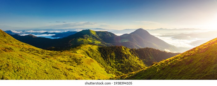 Splendid mountain valley is covered with fog on a sunny day with green alpine meadows. Location place Carpathian mountains, Ukraine, Europe. Vibrant photo wallpaper. Discover the beauty of earth. - Shutterstock ID 1938394105