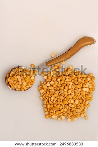 Split Chickpea Also Know as Chana Dal, Dried Chickpea Lentils or Toor Dal, Heap of yellow split chickpeas, Raw lentil, Pakistani Indian beans isolated on white Background
