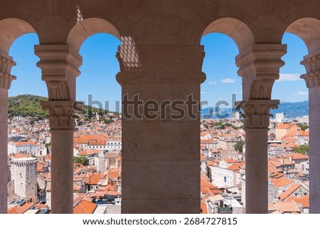 Split city view through old stone arches