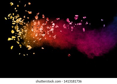 Split Debris Of Colored Stone With Dust Exploding Against Black Background.