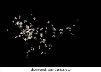 Split Debris Of Stone Exploding Against Black Background.