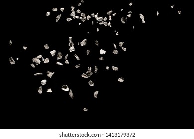 Split Debris Of Stone Exploding Against Black Background.