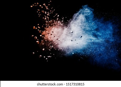 Split Debris Of Stone Exploding With Blue Red Powder Against Black Background.