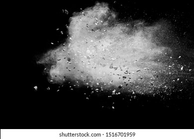 Split Debris Of Stone Exploding With White Powder Against Black Background.