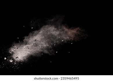Split debris of  stone exploding with white powder against black background. - Shutterstock ID 2359465495