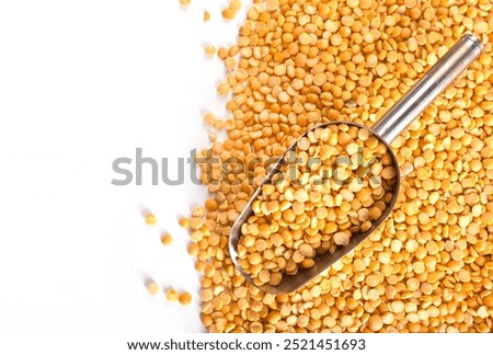 split dry peas are lying on the table, dry peas in metal spoon
