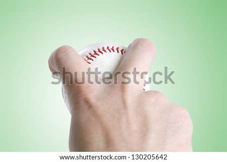 Split Finger Grip - Clipping Path split finger baseball grip on green gradient background. with clipping path to place your own background. focus is on ball and fingers.