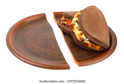 The Split Food Dish Is Isolated On A White Background. Broken Plate.