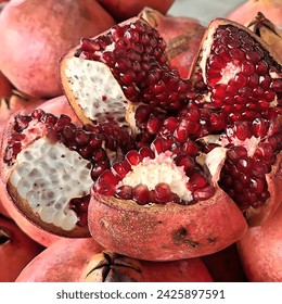 A split open pomegranate, exposing the juicy red arils inside. pomegranate #pomegranates #fruit #healthy #food #delicious #antioxidants #vitamins #minerals #fiber #antiinflammatory #hearthealth 