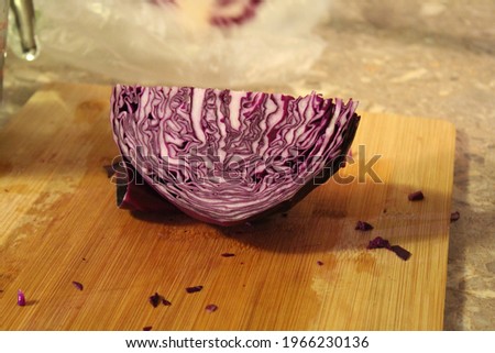 Split Red Cabbage Sitting on a Cutting Board