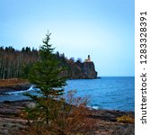 Split Rock Lighthouse on the north shore of Lake Superior near Duluth and Two Harbors, Minnesota. Evergreen tree in foreground.