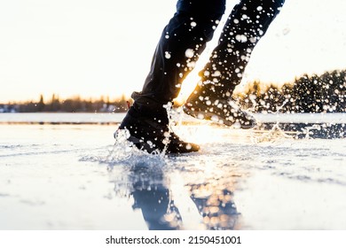 Split Second Moment While Person Is Running Through A Water Puddle