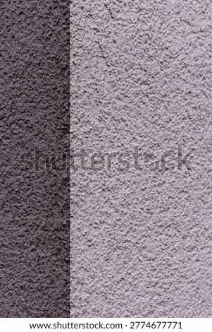 Split textured plaster wall with gray tones