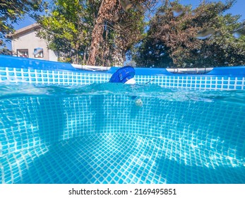 Split Underwater View Of A Chlorine Floater Dispenser In A Pool Of A Private House