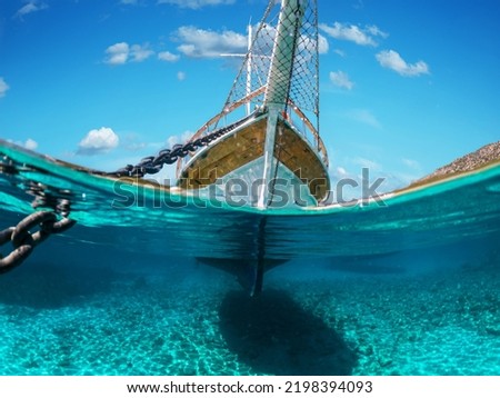 Split view - half underwater view of beautiful seabed with sea fishes and beautiful marine yacht, Turkey, Bodrum.