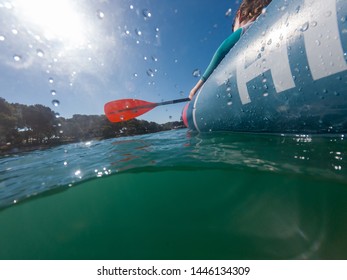 Split View Of Unrecognizable Female Rower In Inflated Boat Rowing.