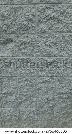 a split-face concrete block wall, commonly used for building facades. abstract construction background with copy space.