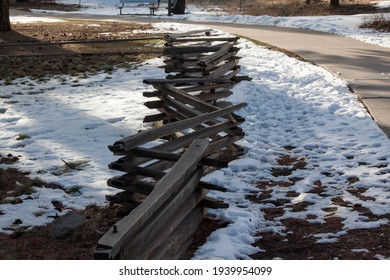 Split-rail fencing in a zig zag pattern on snow covered ground in Northern Arizona.