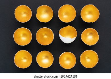 Splurge concept. Golden eggshell isolated on black background. Glamorous eggs. Creative Easter design template for advertising banners, invitations. The concept of making a permanent profit. - Shutterstock ID 1919627159