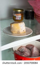 Spoiled Cheese Covered With Mold On A Shelf In The Refrigerator.