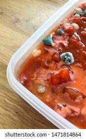 Spoiled Food In Plastic Container. Rotten Tomato Soup, Food Forgotten In The Fridge.