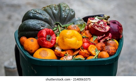 Spoiled fruits and vegetables. Food loss and Food Waste on the Farm or a market - Shutterstock ID 2140061075